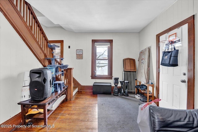 interior space with wood-type flooring and radiator heating unit