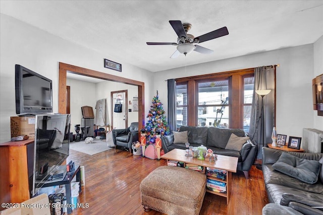 living room with wood-type flooring and ceiling fan