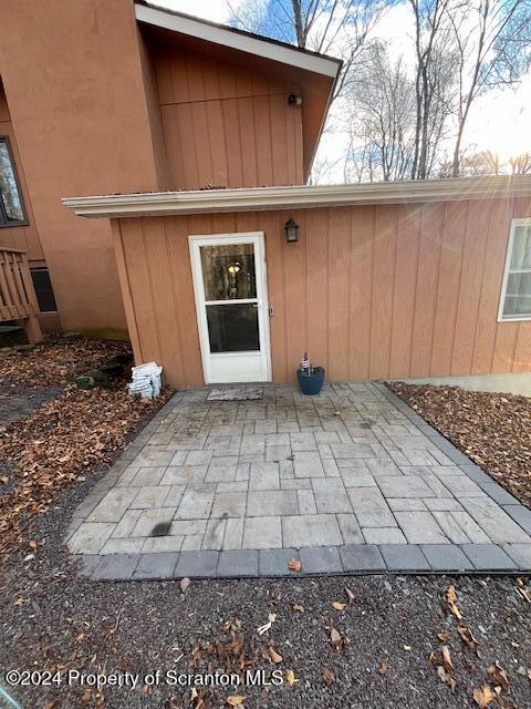 entrance to property featuring a patio area