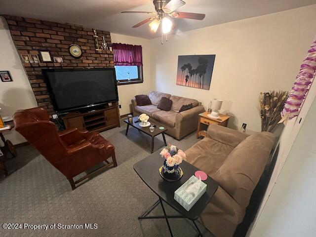 living room featuring carpet flooring and ceiling fan