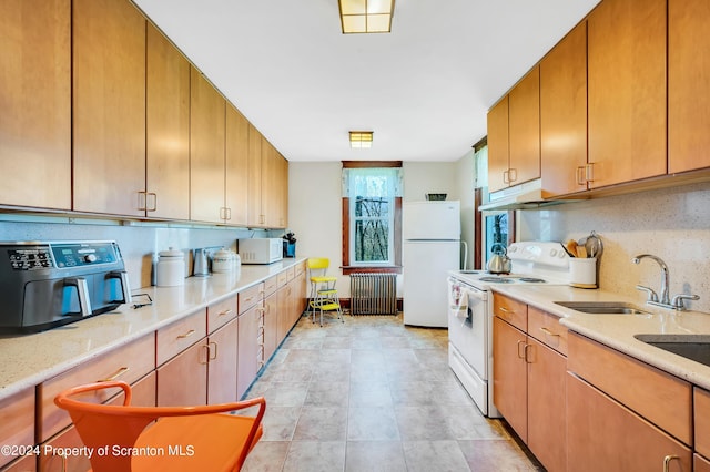 kitchen with backsplash, radiator heating unit, white appliances, and sink