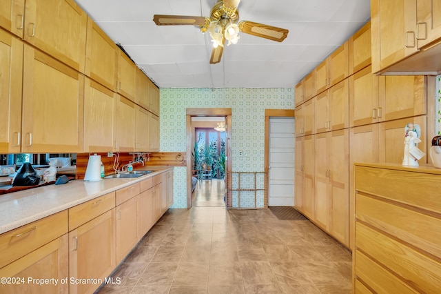 kitchen featuring light brown cabinetry, ceiling fan, and sink