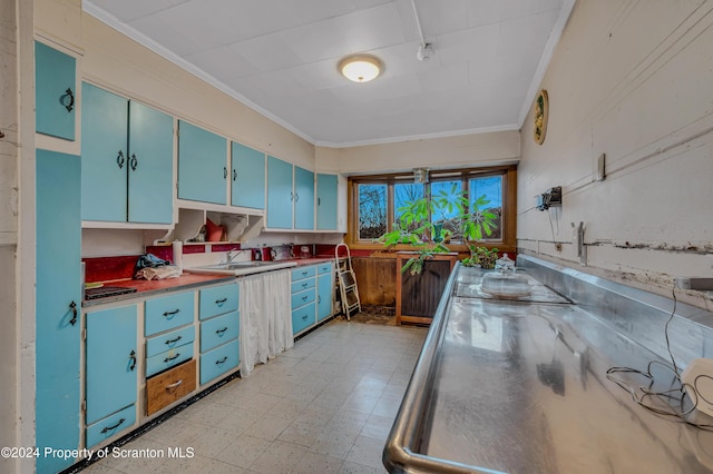 kitchen featuring stainless steel counters, sink, ornamental molding, and blue cabinetry