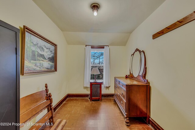 corridor with lofted ceiling