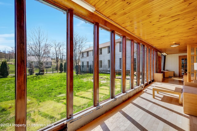 unfurnished sunroom with wooden ceiling