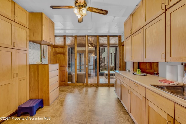 kitchen with ceiling fan and light brown cabinets