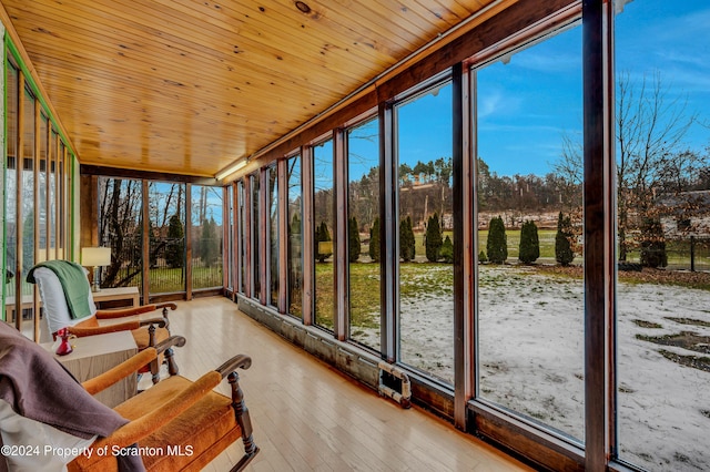 unfurnished sunroom with a healthy amount of sunlight and wood ceiling