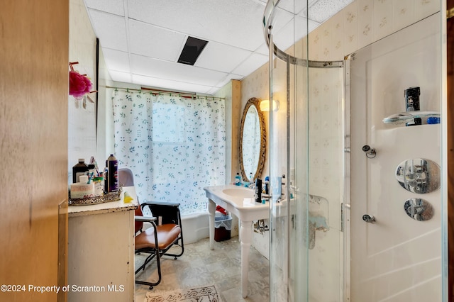 bathroom with a paneled ceiling and a shower