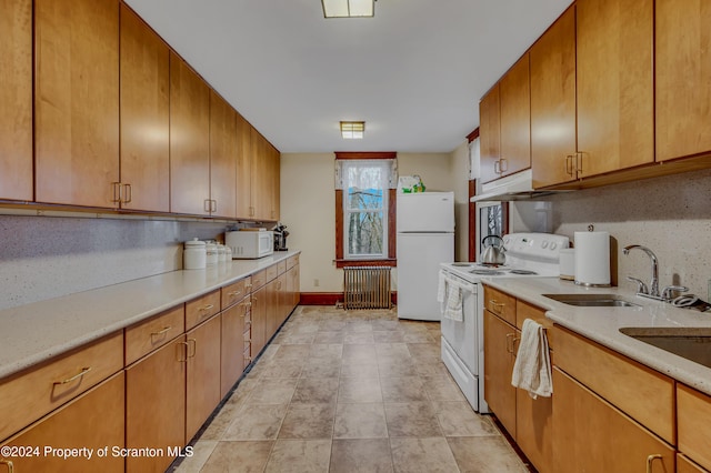 kitchen featuring sink, white appliances, and backsplash