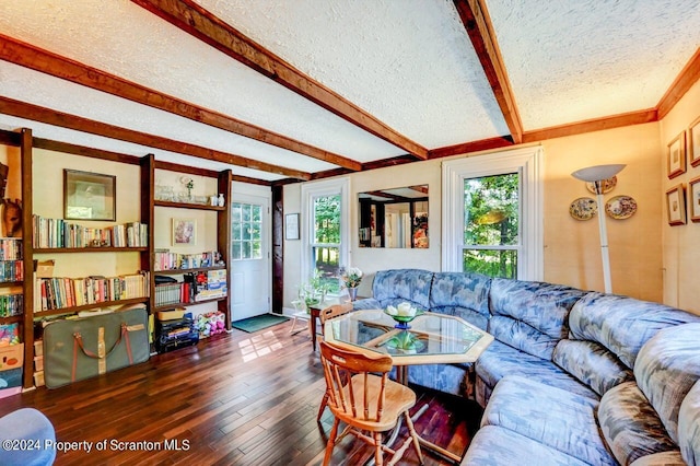 living room with dark hardwood / wood-style floors, beam ceiling, a textured ceiling, and a wealth of natural light