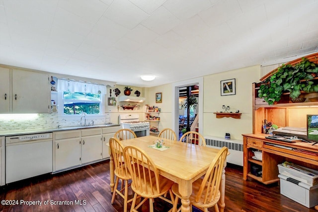 dining room featuring radiator heating unit, dark wood-type flooring, and sink