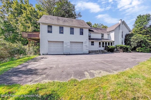 view of front of house featuring a garage and a wooden deck