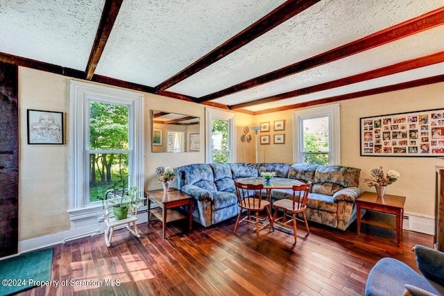 living room with dark hardwood / wood-style flooring, beamed ceiling, a textured ceiling, and a baseboard heating unit