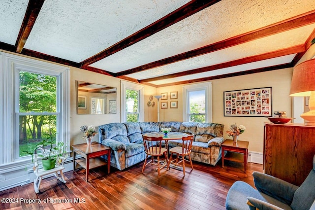 living room with beamed ceiling, dark hardwood / wood-style floors, baseboard heating, and a textured ceiling