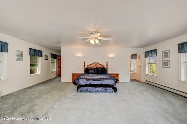 bedroom with baseboard heating, ceiling fan, and light colored carpet