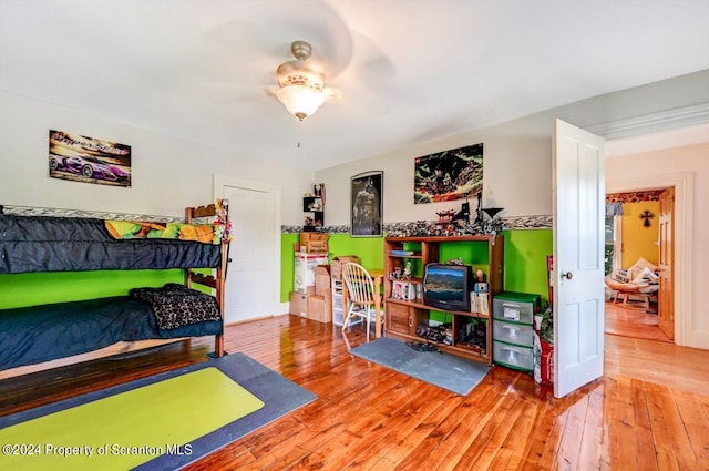 bedroom with ceiling fan and hardwood / wood-style floors