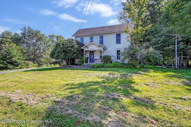 colonial inspired home with a front lawn