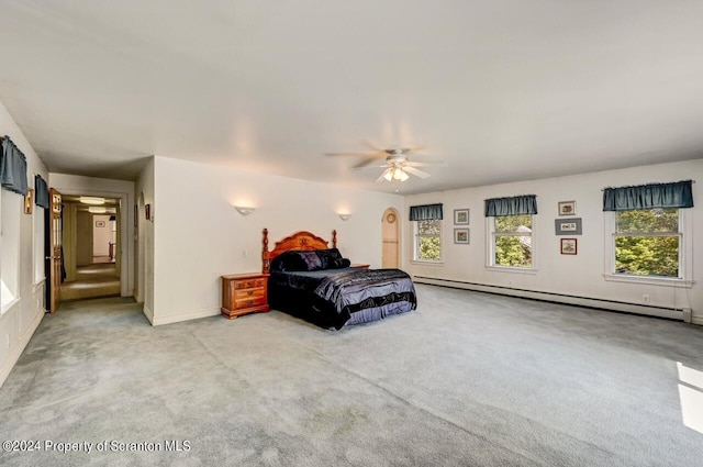 carpeted bedroom featuring baseboard heating and ceiling fan