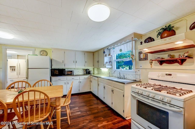 kitchen featuring white appliances, dark wood-type flooring, sink, decorative backsplash, and range hood