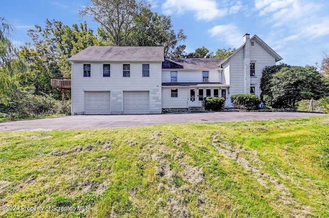 view of front of home featuring a garage and a front lawn