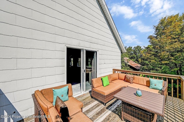 wooden deck with an outdoor living space