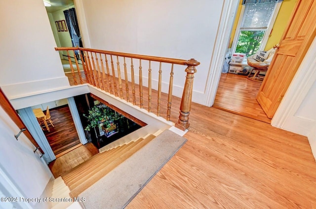 stairs featuring hardwood / wood-style floors