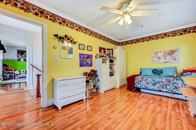 bedroom with ceiling fan, crown molding, and light hardwood / wood-style floors