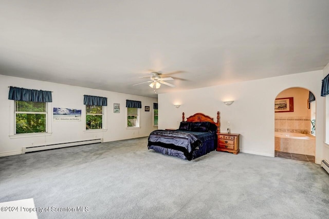 carpeted bedroom featuring baseboard heating, ceiling fan, and ensuite bathroom