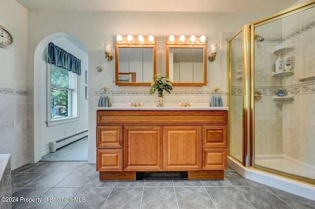 bathroom with vanity, tile patterned floors, a shower with door, and a baseboard heating unit