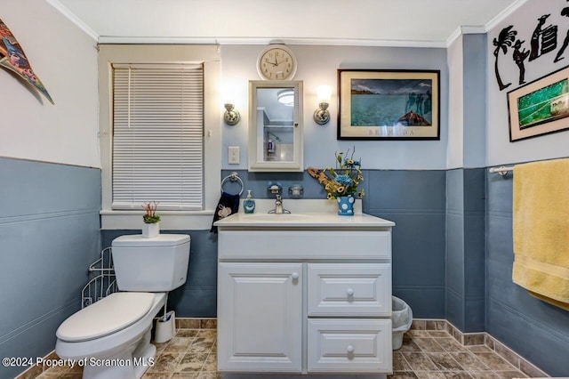 bathroom with vanity, toilet, and crown molding