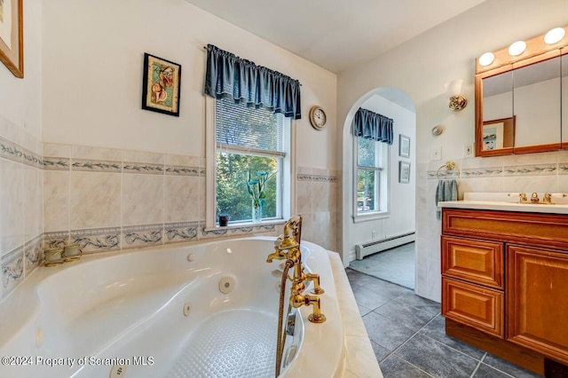 bathroom featuring vanity, tile patterned flooring, tile walls, a baseboard radiator, and a tub