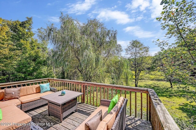 wooden deck with a lawn and an outdoor hangout area