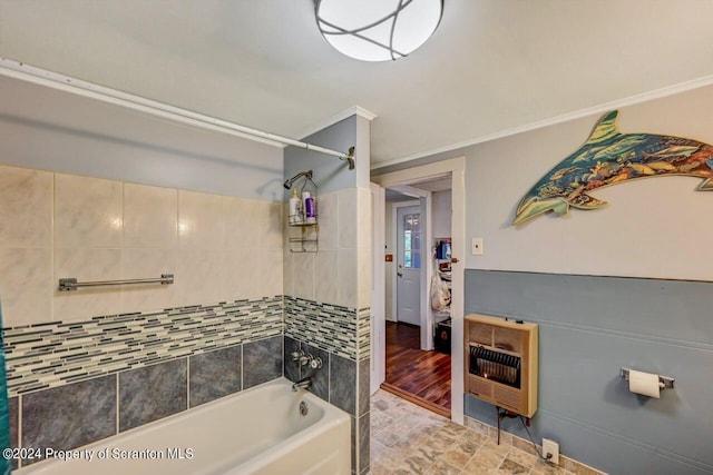 bathroom featuring heating unit and tiled shower / bath combo