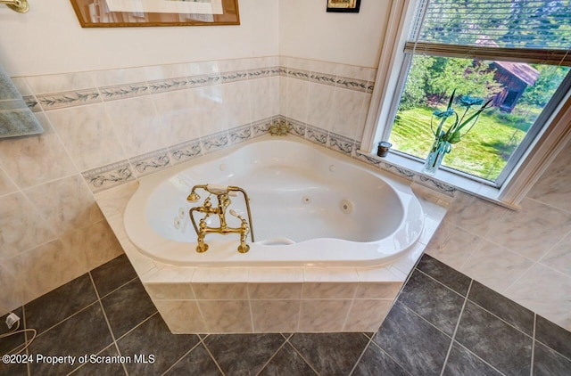 bathroom featuring tile patterned flooring, a relaxing tiled tub, and a healthy amount of sunlight