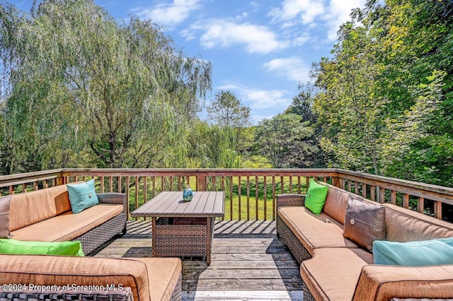 wooden deck with an outdoor living space