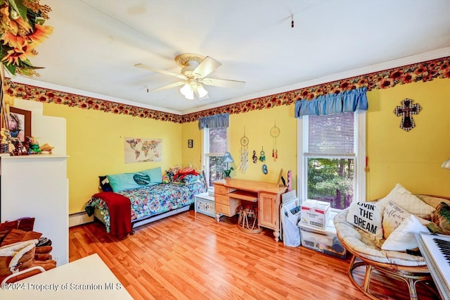 bedroom featuring ceiling fan, light hardwood / wood-style floors, ornamental molding, and a baseboard radiator