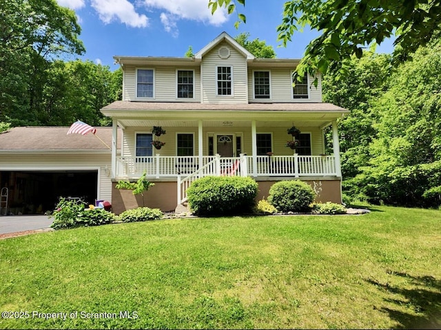 view of front of house with a garage, a front yard, and a porch