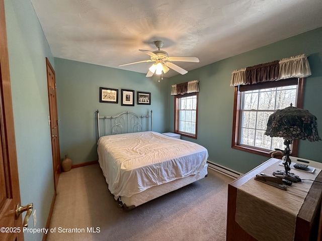 bedroom featuring ceiling fan, light carpet, and baseboard heating