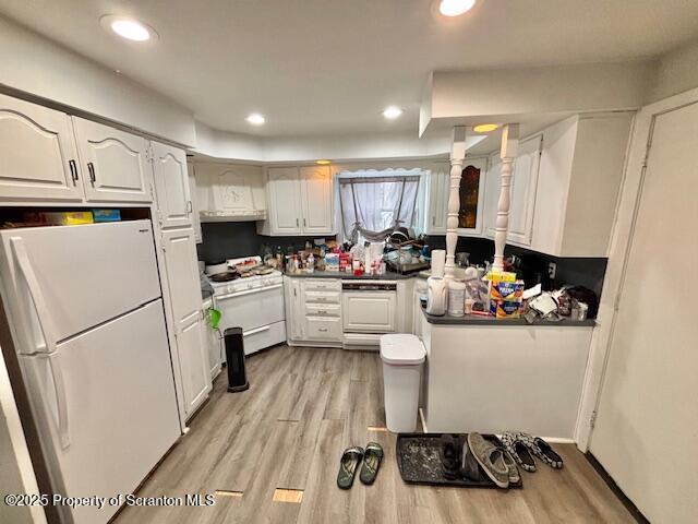 kitchen featuring light wood-type flooring, white appliances, white cabinetry, and recessed lighting