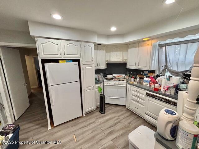 kitchen with white cabinets, white appliances, light wood finished floors, and recessed lighting