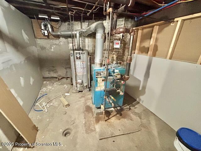 utility room featuring a heating unit and gas water heater