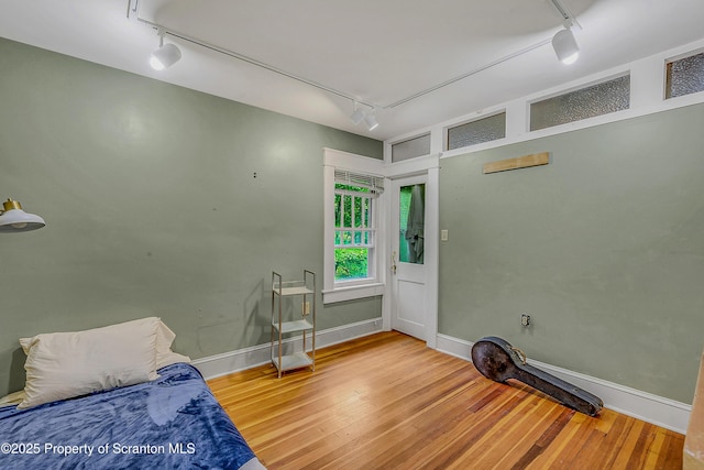 837 Old State Rd, Waverly Twp, PA 18411 - bedroom with track lighting, wood finished floors, and baseboards