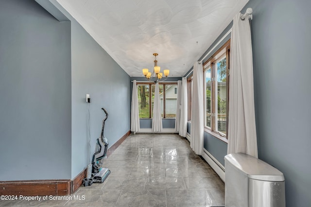 doorway with a baseboard heating unit and a notable chandelier