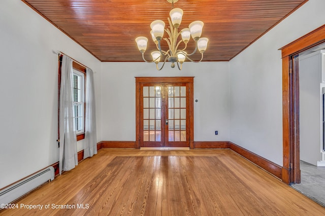 empty room with french doors, ornamental molding, a baseboard heating unit, a notable chandelier, and light hardwood / wood-style floors