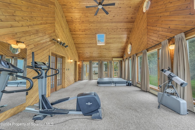 exercise room with ceiling fan, wood walls, wooden ceiling, and carpet floors