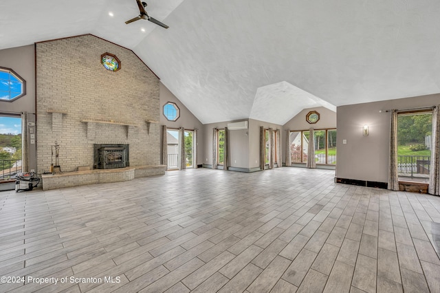 unfurnished living room featuring a wall mounted AC, high vaulted ceiling, and ceiling fan