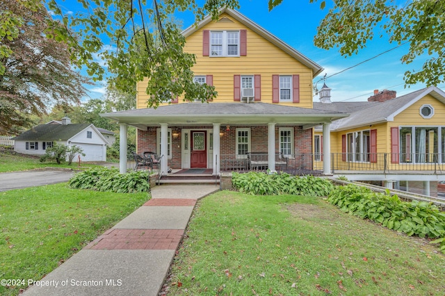 farmhouse with a porch and a front yard