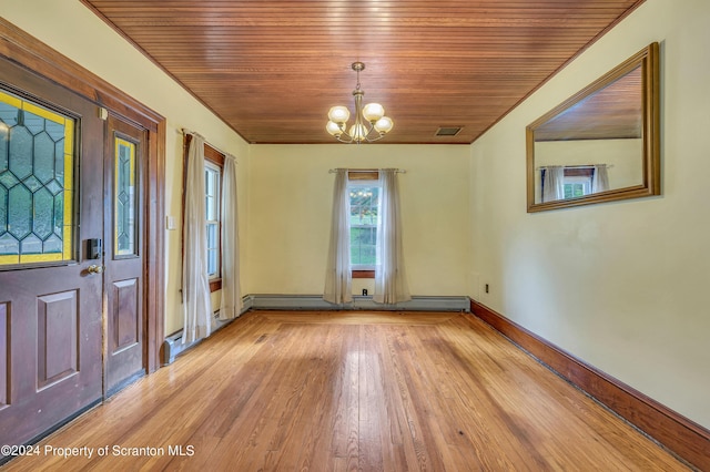 foyer entrance featuring a notable chandelier, light wood-type flooring, wood ceiling, and a baseboard heating unit