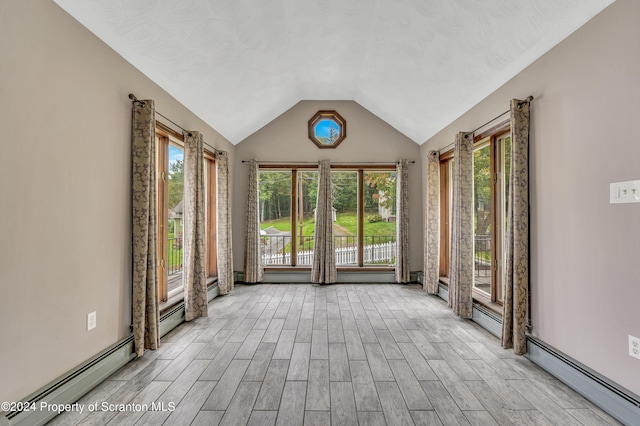 interior space featuring a healthy amount of sunlight, a baseboard radiator, and vaulted ceiling