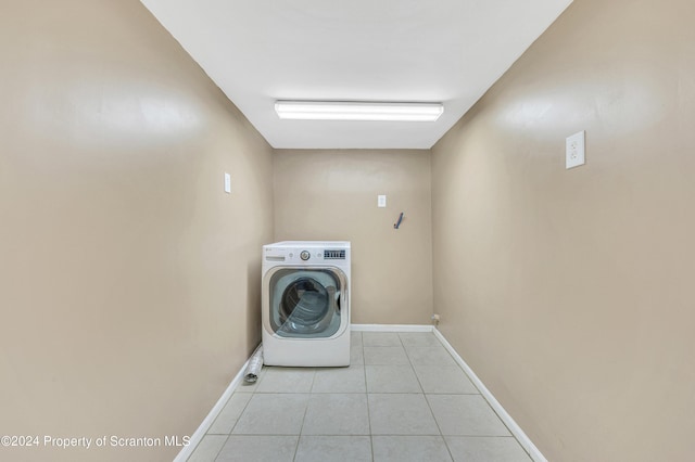 washroom with washer / dryer and light tile patterned floors